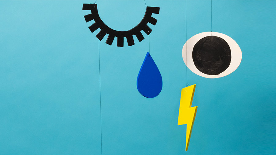Abstract illustration showing a mobile which has four items representing crying: an eye, an eyelash, a tear and a lightning bolt