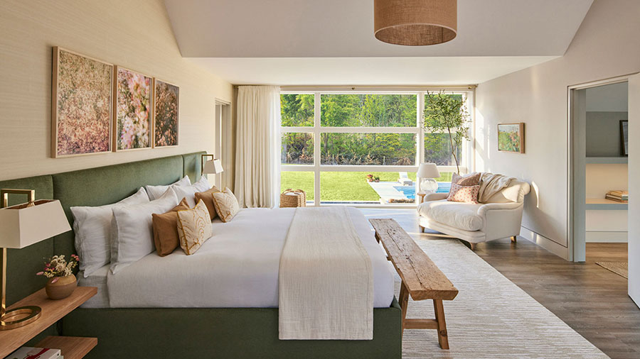 Omaze Cotswolds house large master bedroom with floor-to-ceiling windows overlooking lawn