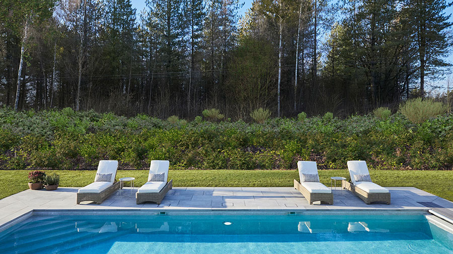 Omaze Cotswolds house swimming pool with four loungers at one side