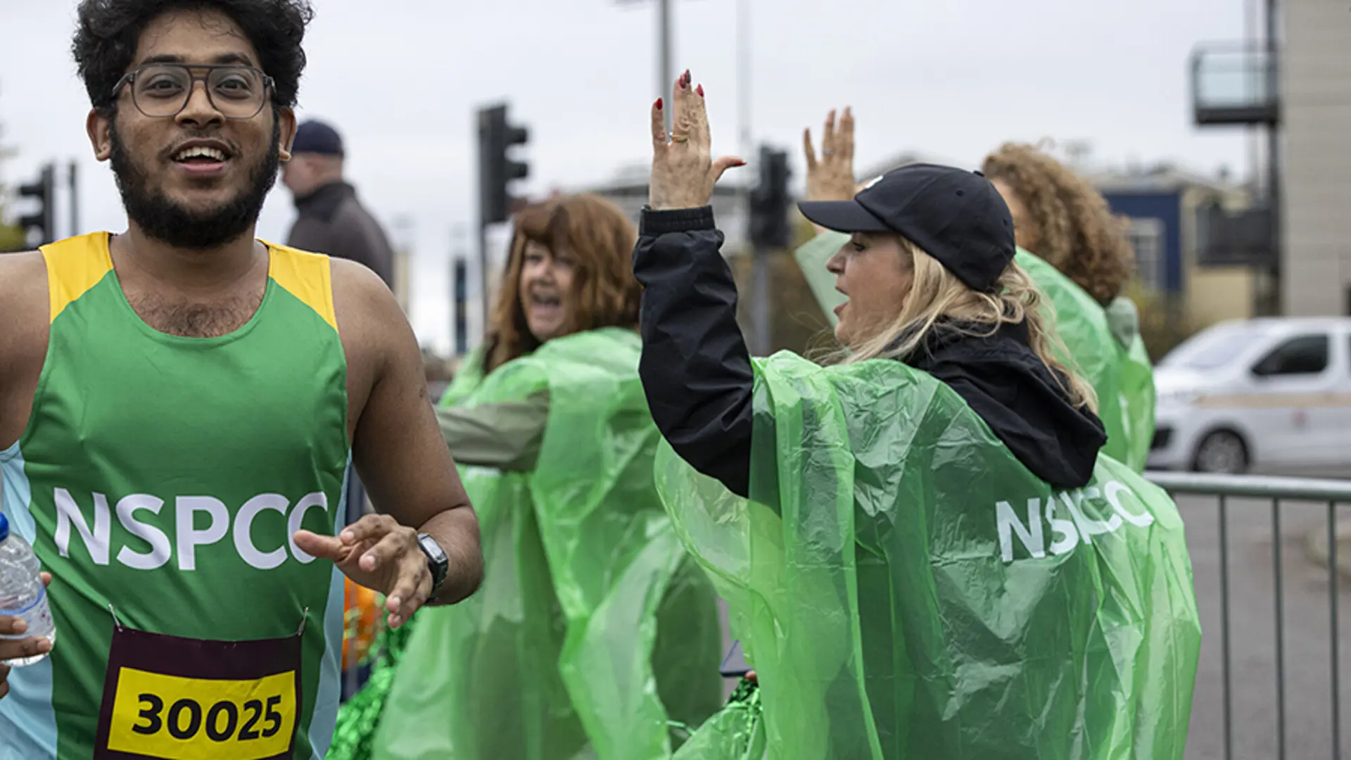 A member of Team NSPCC smiling while taking part in a running event.